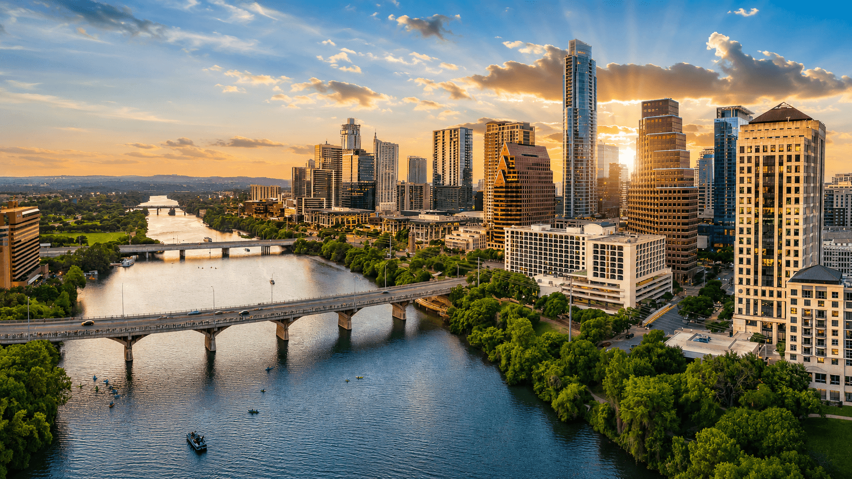 Austin skyline at sunset over Lady Bird Lake and the Congress Avenue bridge
